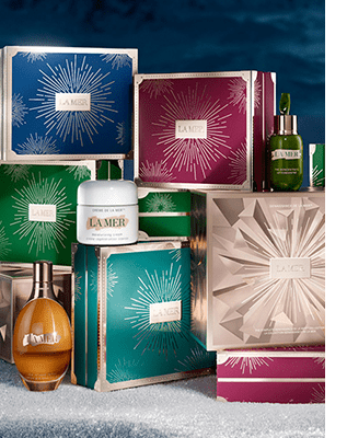 La Mer Christmas Gift Sets stacked in a winter setting